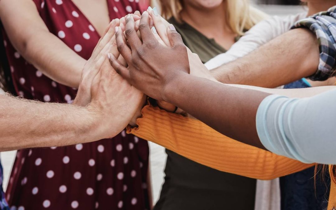group of people stacking hands
